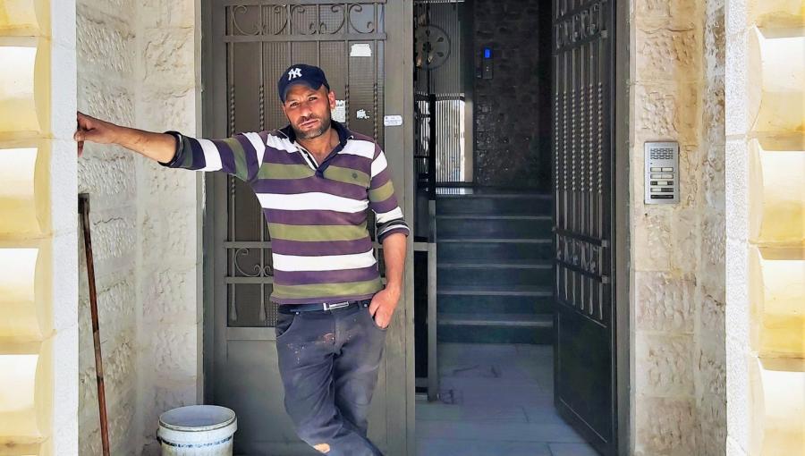 حارس أمام إحدى البنايات التي يعمل فيها في عمان | المصدر: حبر