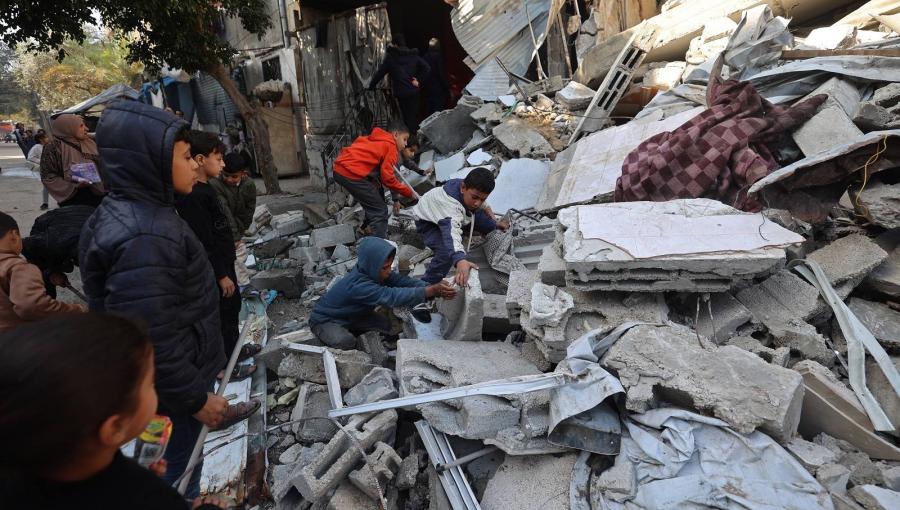 أطفال يبحثون عن أشيائهم وسط أنقاض منزلهم المنهار وكان قد تضرر سابقا جراء غارة إسرائيلية في مخيم المغازي وسط قطاع غزة 5/1/2026 | المصدر: وكالة الأنباء الفرنسية