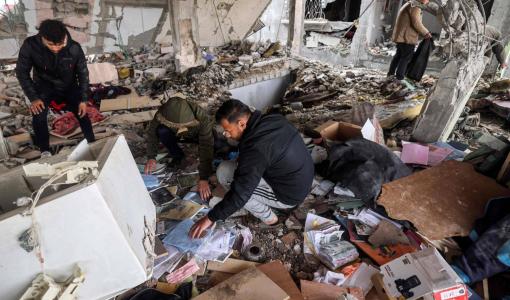 فلسطينيون يبحثون بين أنقاض وحطام مبنى قصفه الاحتلال الإسرائيلي في رفح جنوب قطاع غزة | المصدر: وكالة الأنباء الفرنسية