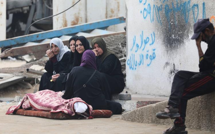 فلسطينيات يجلسن أمام جثمان شهيد قضى في غارة إسرائيلية بمدينة غزة 29/10/2025 | أسوشييتد برس