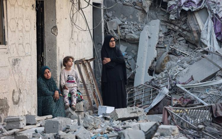 امرأتان وطفلة وسط أنقاض منزل دمرته غارات الاحتلال على غزة | وكالة الأنباء الفرنسية