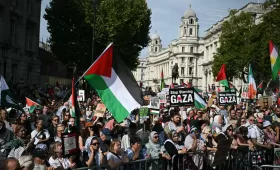 أشخاص يحملون لافتات وأعلاما فلسطينية خلال مسيرة من أجل غزة في لندن | وكالة الأنباء الفرنسية